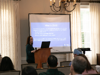 Photos of presenter during the UMMC OB-GYN Quality and Safety Symposium 2024